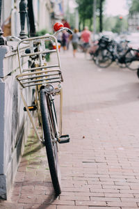 Bike with a basket leaning on a wall in amsterdam streets, holland, netherlands.