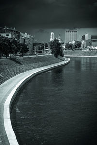 Street by swimming pool against buildings in city