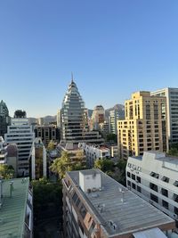 Low angle view of buildings against clear blue sky