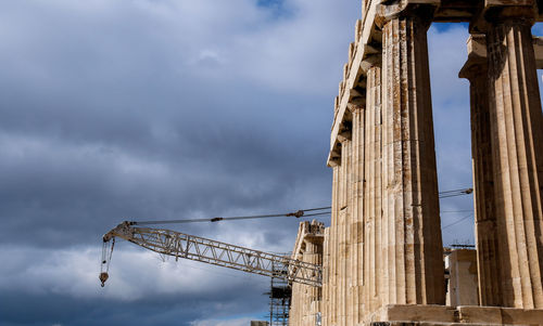 Low angle view of crane against sky