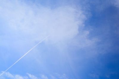 Low angle view of vapor trail in blue sky