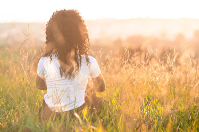 Woman standing on field against sky