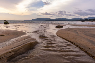 Scenic view of beach against sky during sunset