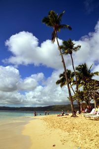 Scenic view of beach against cloudy sky