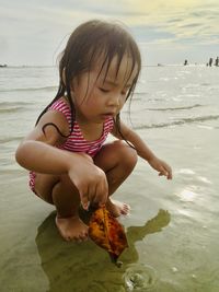 Full length of cute girl on beach