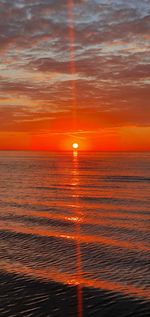 Scenic view of sea against romantic sky at sunset