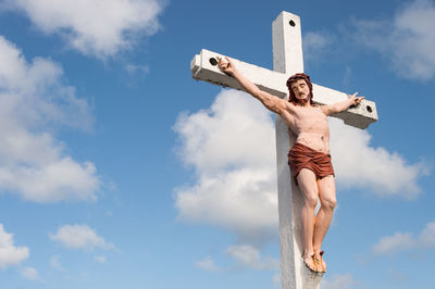 Low angle view of young man against sky