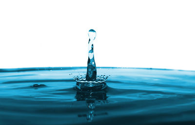 Close-up of water splashing against blue background