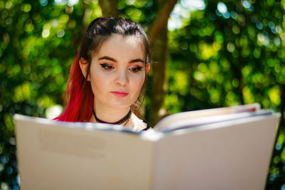 Woman reading file at park