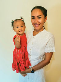 Thai mother with her thai-german baby in self crocheted dress