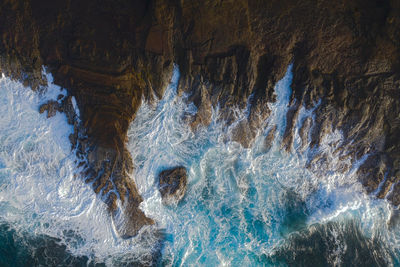 Aerial view of rock formations in sea