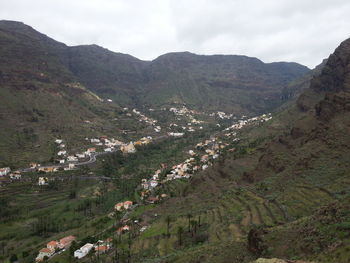 High angle view of valley and mountains against sky