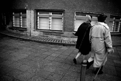 Rear view of man walking in building