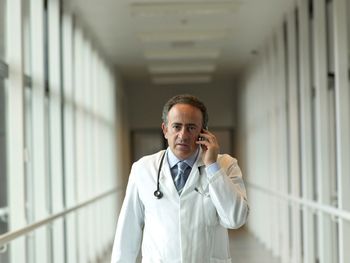 Portrait of doctor using mobile phone in hospital