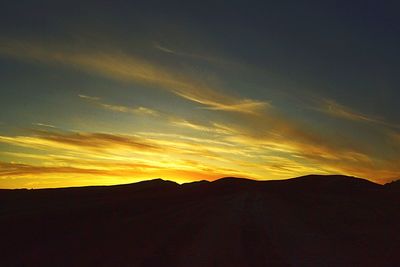 Silhouette landscape against sky during sunset