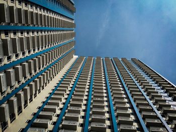 Low angle view of modern building against blue sky