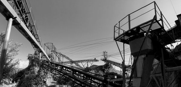 Low angle view of cables against sky during winter