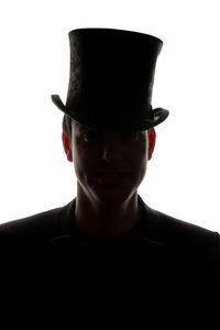Portrait of young man wearing hat against white background