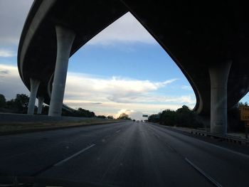 View of highway against cloudy sky
