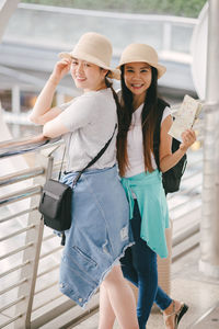 Tourists standing on footbridge in city