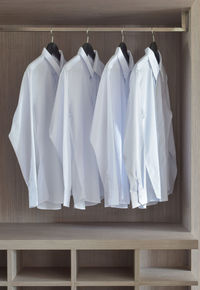 Clothes drying on clothesline against white background