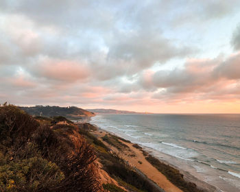 Scenic view of beach against sky during sunset