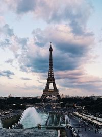 Melancholic tour eiffel against cloudy sky