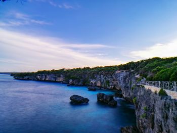 Scenic view of river against blue sky