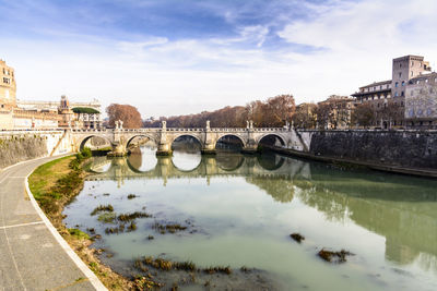 View of bridge over river against cloudy sky
