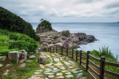 Rocks by sea against sky