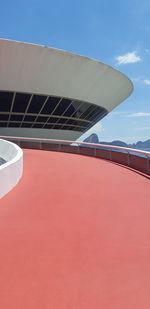 Low angle view of modern building against blue sky