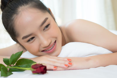 Young woman lying on massage table in spa