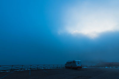 Road by sea against blue sky