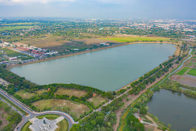 High angle view of river amidst cityscape against sky