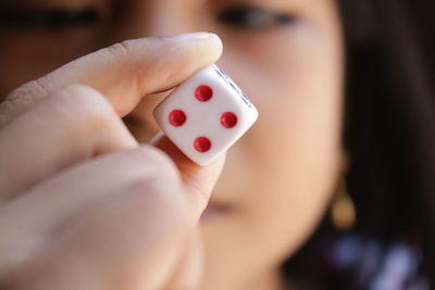 Close-up of girl holding dice