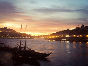 Sailboats in sea at sunset