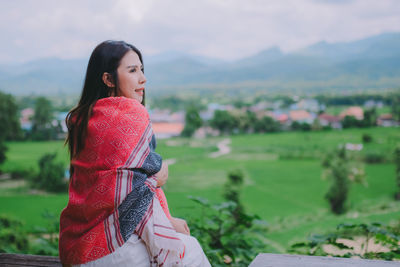 Young woman standing on field