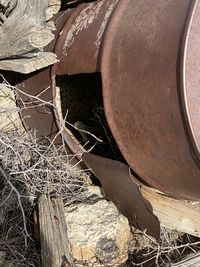 Close-up of old rusty stack on wood