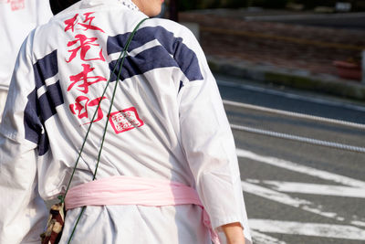 Midsection of person in traditional clothing on street