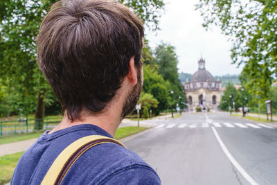 Rear view of woman walking on road