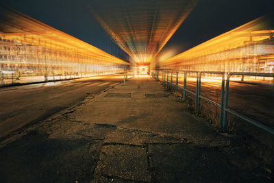 Illuminated road in city at night