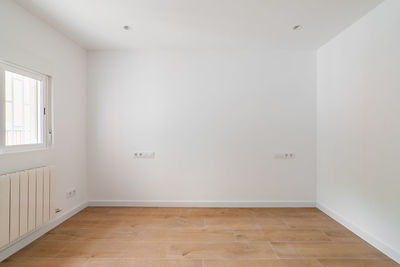 Empty white room with window and natural light. interior of the freshly renovated room.