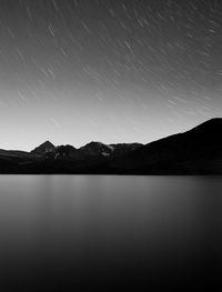 Scenic view of lake against sky at night