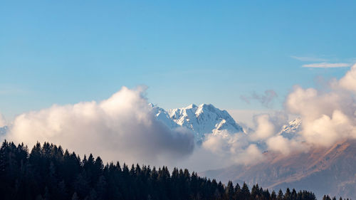 Low angle view of snowcapped mountains against sky