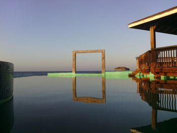 Rare view of infinity pool against calm sea