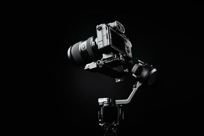 Camera mounted on gimbal on dark background. electronic steadicam
