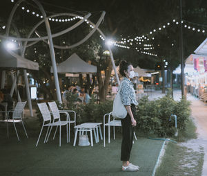 Series photo of young woman tourist wear surgical medical mask touring in street night market