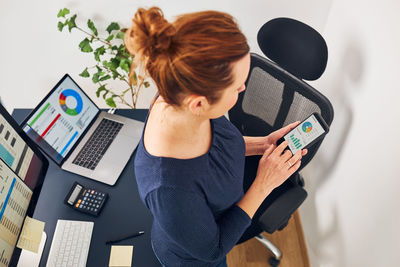 Rear view of woman using mobile phone