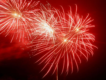 Low angle view of firework display at night