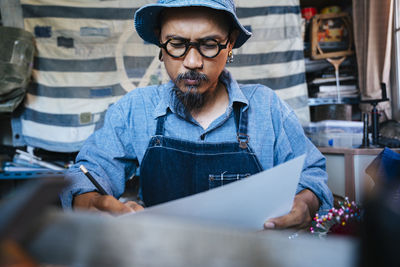 Man working over paper on table